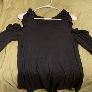 Black long sleeve T-shirt. Ruffles on shoulders with shoulder cut out.